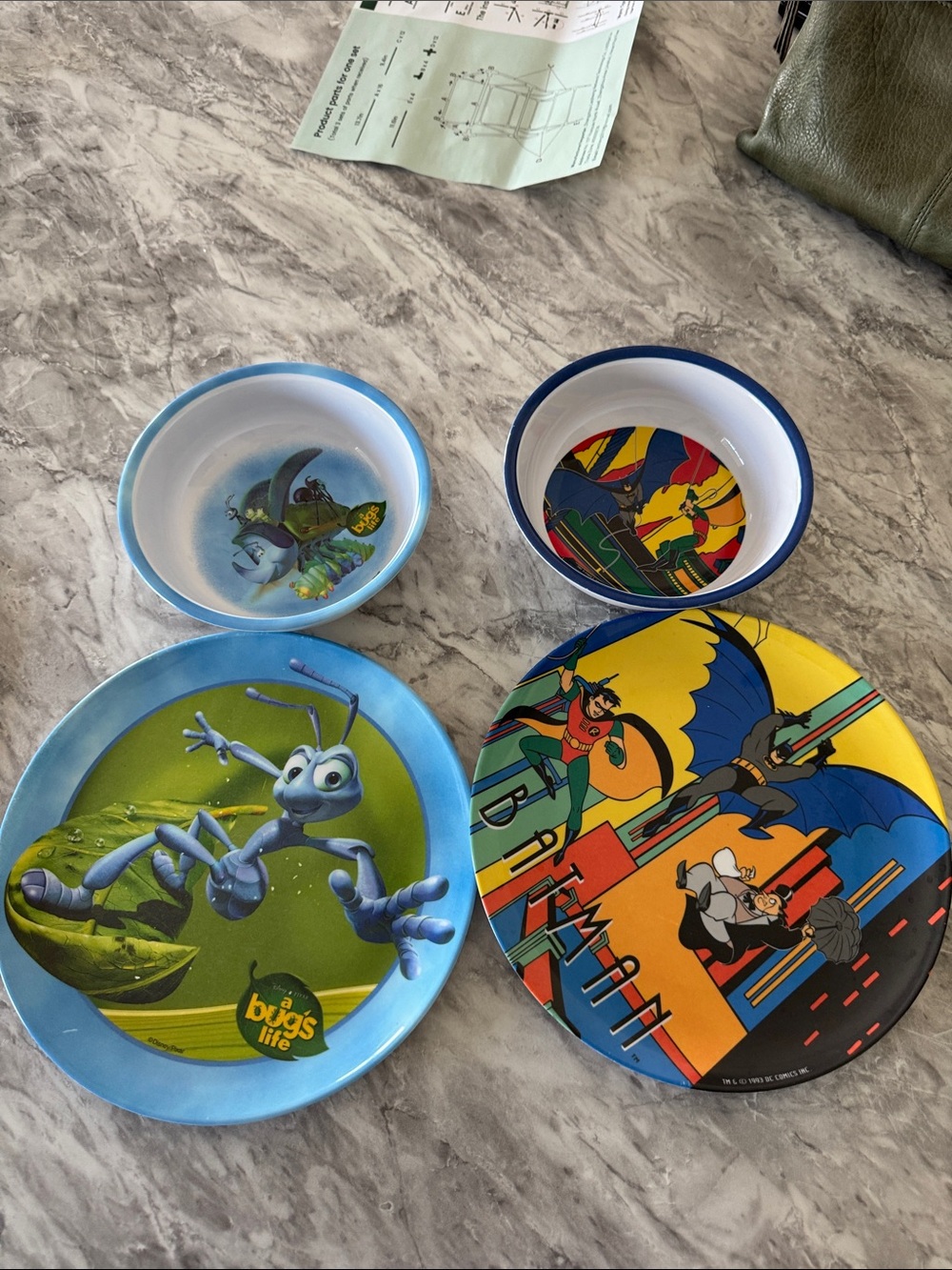 A Bug's Life Kids plate and bowl and a Batman and Robin plate and bowl set.